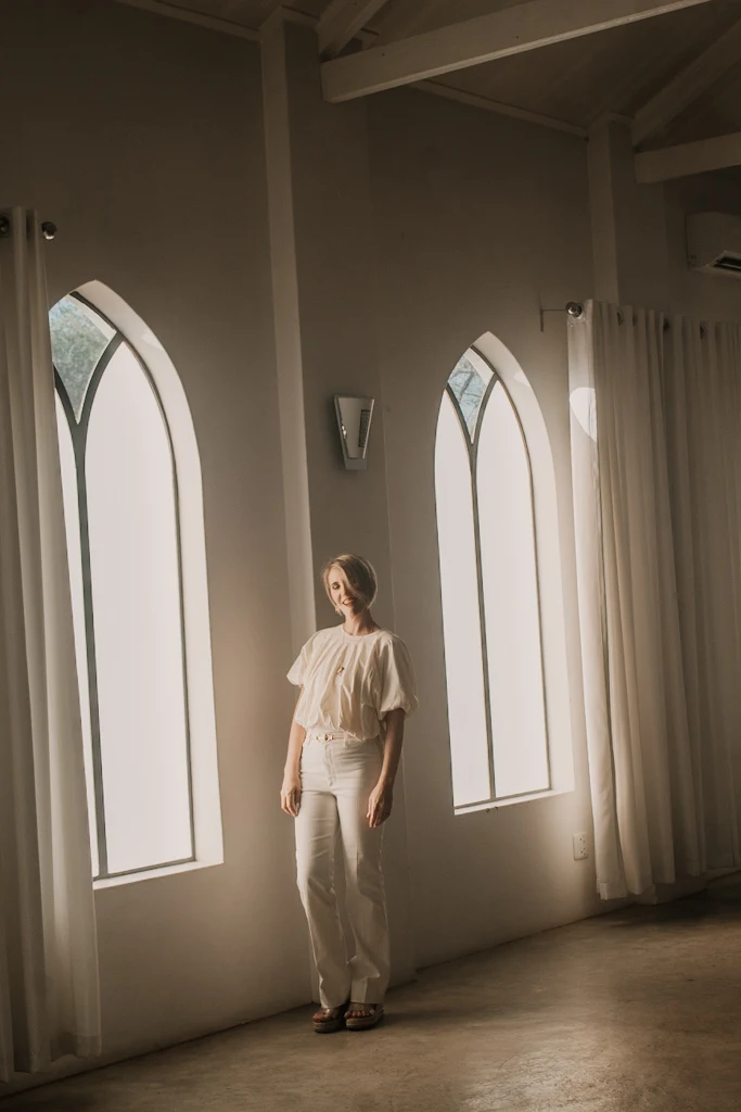 Bianca beside a church window during the Stillness shoot